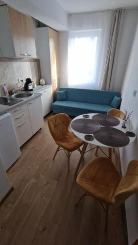 a kitchen with a table and chairs in a room at Ap CALAS No2 2B, Free Parking in Râşnov