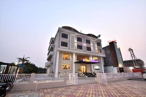 a building with a white fence in front of it at Click Collection Grand Gateway Varanasi in Varanasi