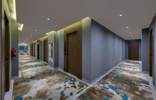 a hallway with a row of doors and a tile floor at Click Collection Grand Gateway Varanasi in Varanasi