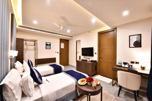 a hotel room with a bed and a table at Click Collection Grand Gateway Varanasi in Varanasi