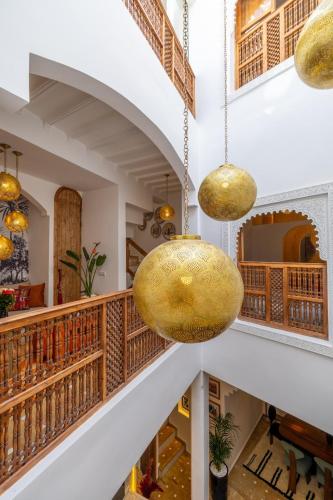 a hallway with two large gold pendant lights at Riad Dar Catalia-Exclusive&HeatedPool-FreeBreakfas in Marrakech