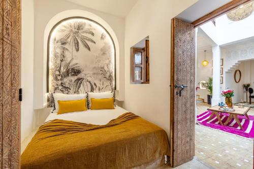 a bedroom with a large bed with yellow pillows at Riad Dar Catalia-Exclusive&HeatedPool-FreeBreakfas in Marrakech