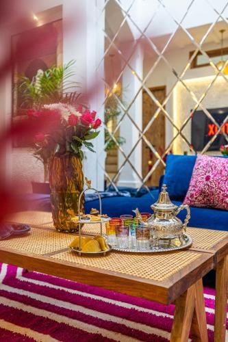 a coffee table with a vase of flowers on it at Riad Dar Catalia-Exclusive&HeatedPool-FreeBreakfas in Marrakech