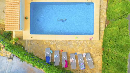 an overhead view of a swimming pool with pairs of shoes at Villa Carola - PlusHolidays in Ifach