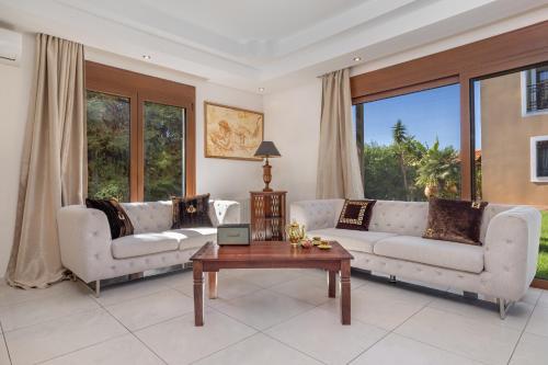a living room with two couches and a table at Luxury Mansion Rhodes in Ialyssos
