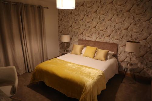 a bedroom with a bed with a stone wall at Ballydonnellan in Westport