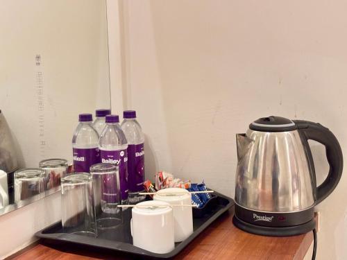 a tea kettle and several bottles of water on a counter at Vyom Boutique Hotel Rishikesh in Rishīkesh
