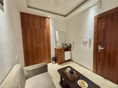 a living room with a couch and a table at Vyom Boutique Hotel Rishikesh in Rishīkesh