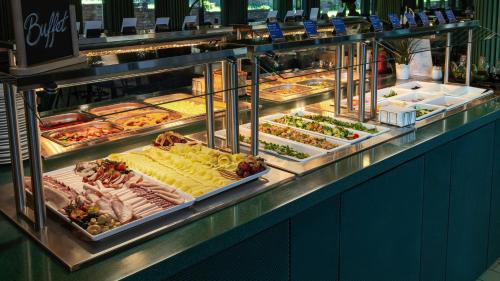a buffet line with many different types of food at Wellton Riverside SPA Hotel in Rīga