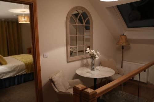 a room with a table and chairs and a bed at Ballydonnellan in Westport