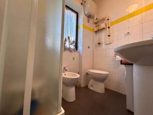 a bathroom with a toilet and a sink at La Casetta in Montagna by Holiday World in Lucoli Alto