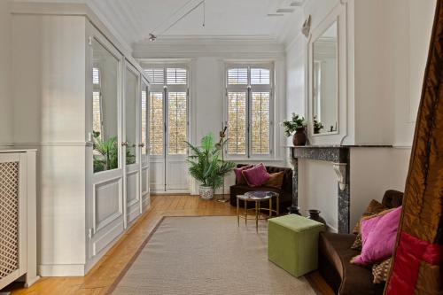 a living room with a couch and a fireplace at Le Papillon Antwerp Suite 3 in Antwerp