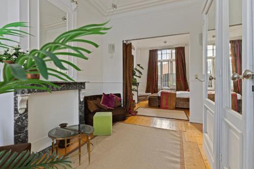 a living room with a fireplace and a bedroom at Le Papillon Antwerp Suite 3 in Antwerp