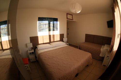a bedroom with a bed and a couch at Oasi Brembate Bed and Breakfast in Brembate