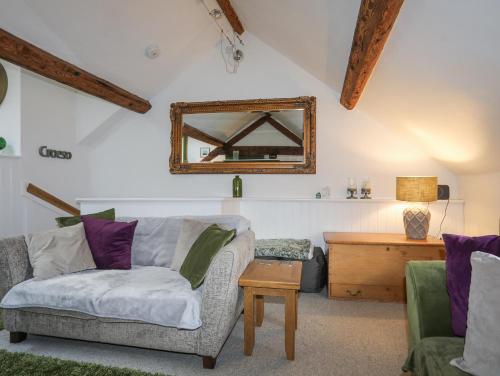 a living room with a couch and a mirror at 34 Wexham Street in Beaumaris