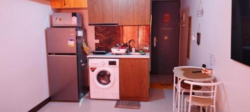 a kitchen with a washing machine and a refrigerator at LBS Condo Rental-Full Relaxing Seaview 304-10Flr in Lapu Lapu City
