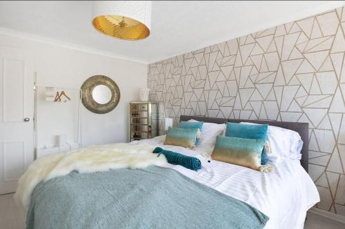 a bedroom with a large bed with two pillows at Luxury Lodge Gillingham with Hot Tub and Parking in Hoo