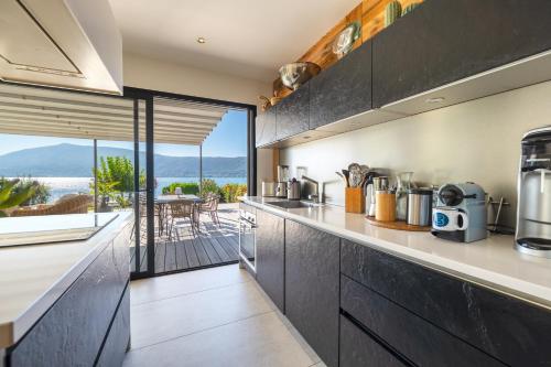 une cuisine avec vue sur l'océan dans l'établissement Villa Belle Rive - Villa les pieds dans l'eau, à Veyrier-du-Lac