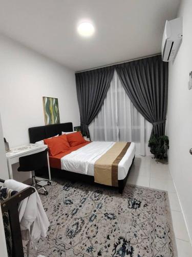 a bedroom with a bed and a desk in a room at AzzSpacesAnderson in Ipoh