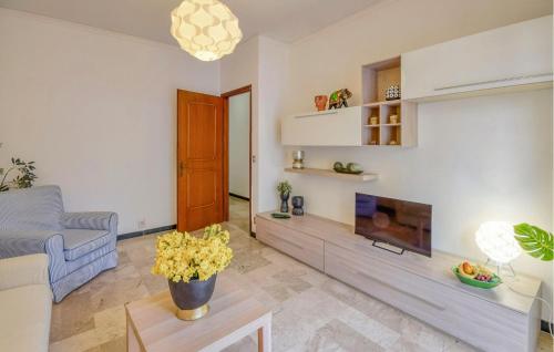 a living room with a couch and a tv at 2 Bedroom Lovely Apartment In Moneglia in Moneglia