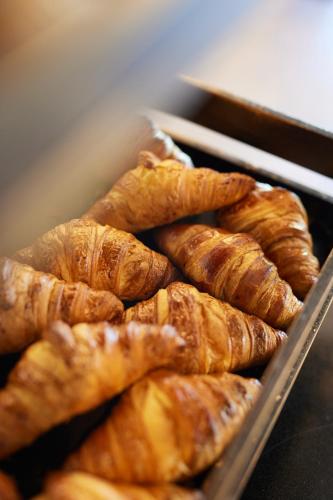 a bunch of croissants are sitting in a tray at Hôtel restaurant Kyriad Fréjus in Fréjus