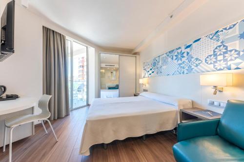 a hotel room with a bed and a desk at Port Benidorm Hotel & Spa 4* Sup in Benidorm