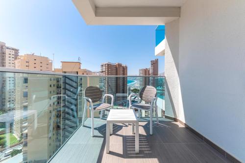 a balcony with chairs and a table on a building at Port Benidorm Hotel & Spa 4* Sup in Benidorm
