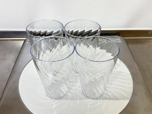 three clear glasses sitting on a plate on a table at Discover Fukuoka House in Fukuoka