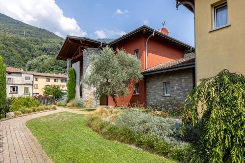 a house with a walkway in front of it at Spluga "Relax & Apartaments" by Alfio Colombo in Sorico