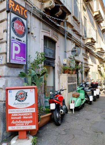 a group of motorcycles parked outside of a building at Homely Catania in Catania