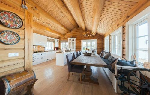 a dining room and kitchen in a log cabin at Stunninng Home In Rauland With Sauna in Rauland