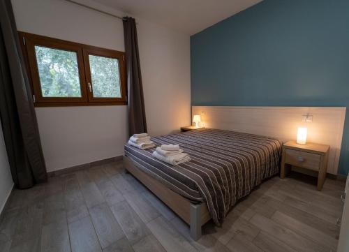 a bedroom with a bed with towels on it at saracena Holiday Home with Private Beach and Swimming Pool in Mattinata