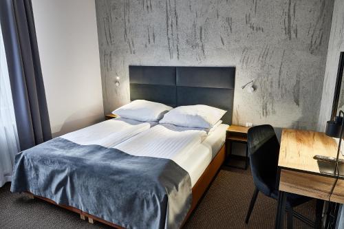 Postel nebo postele na pokoji v ubytování Hotel Baranowski