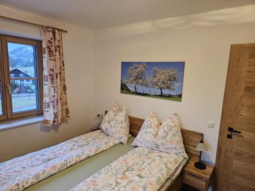 a bedroom with a bed and a window at Ferienhaus Weitblick, Apartment Ritzinger GmbH in Stixenlehen