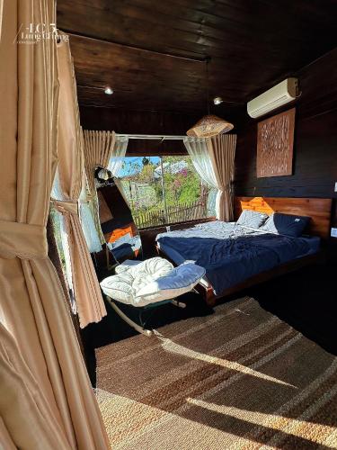 a bedroom with two beds and a window at Lưng Chừng House in Da Lat