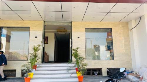 a person standing outside of a building at Taj Comfort Inn in Agra