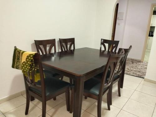 a dining room table and chairs in a room at luxury private 2bhk appartment in Sharjah