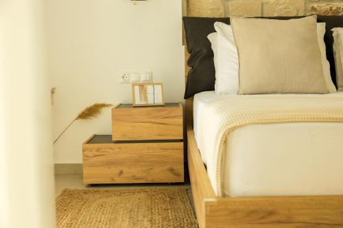 a bedroom with a bed and a wooden nightstand next to it at Nikiti Dream Villas in Nikiti