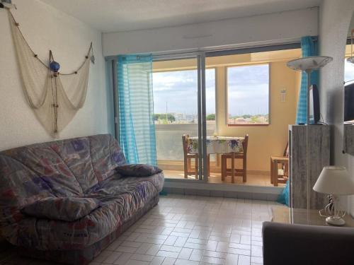 un salon avec un canapé et une table dans l'établissement Appartement CAP D 'AGDE CT040-040, au Cap d'Agde