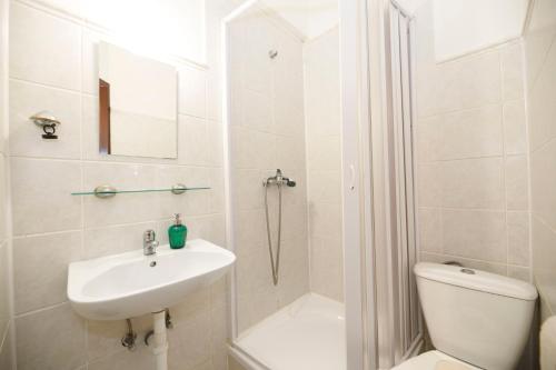 a bathroom with a sink and a toilet and a shower at Horský hotel Kyčerka in Velké Karlovice