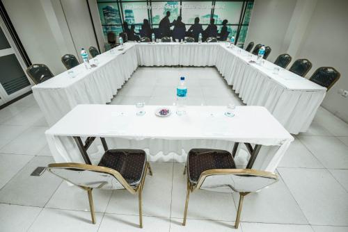 a white table with chairs and a bottle of water on it at Hotel Terminus Maputo in Maputo