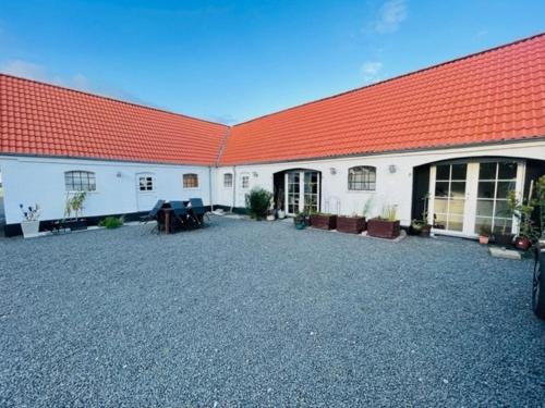 a large white building with a red roof at Entire holiday home in Slagelse