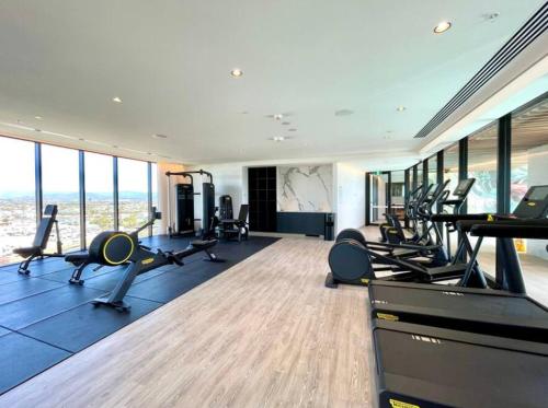 a gym with a bunch of treadmills and exercise equipment at La Jolla Holiday Broadbeach in Gold Coast