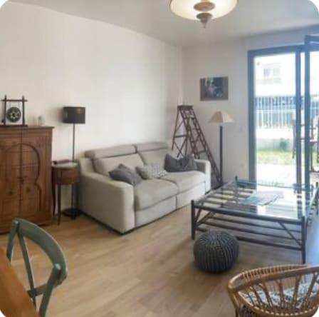 un salon avec un canapé et une table en verre dans l'établissement Le Familial - À deux pas de Paris - 03B, à Rueil-Malmaison