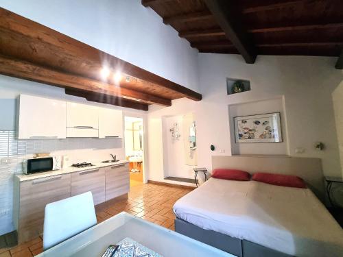 a small bedroom with a bed and a kitchen at H2 Via Saffi in Viterbo