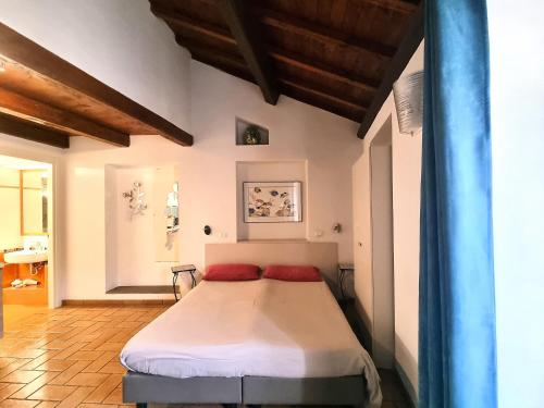 a bedroom with a bed with red pillows on it at H2 Via Saffi in Viterbo
