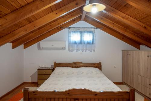 a bedroom with a bed and a window at Villa Elizabeth in Symi