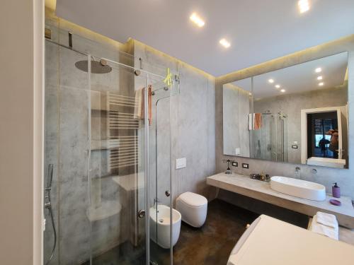 a bathroom with a shower and a toilet and a sink at Lavender Beach House in Draç