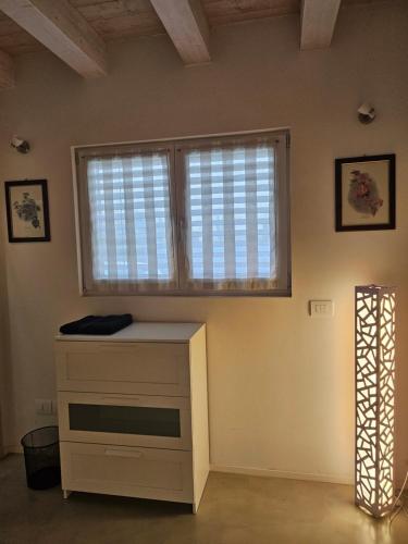 a room with a dresser and a window at CASA MARLU in Vicenza