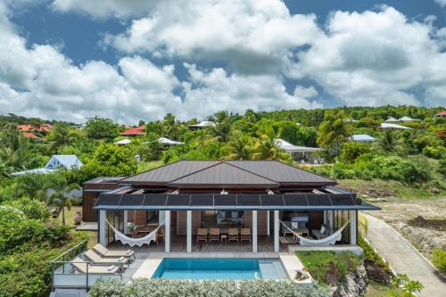 an aerial view of a house with a swimming pool at Villa Ayamé in Grand-Bourg